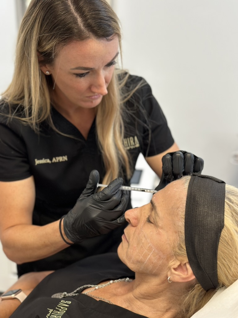 Jessica Wagman performing a procedure on a patient.